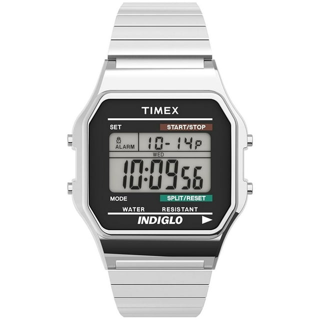 reloj digital timex t78587 33mm clasico indiglo banda extendible acero inoxidable plateado Vista frontal del reloj digital Timex 33 mm con caja rectangular y pantalla digital que muestra hora, segundos, mes y día; botones laterales para modo, start/stop y split/reset; correa de expansión plateada ajustable con eslabones removibles; luz INDIGLO para lectura nocturna y apto para lavarse las manos.