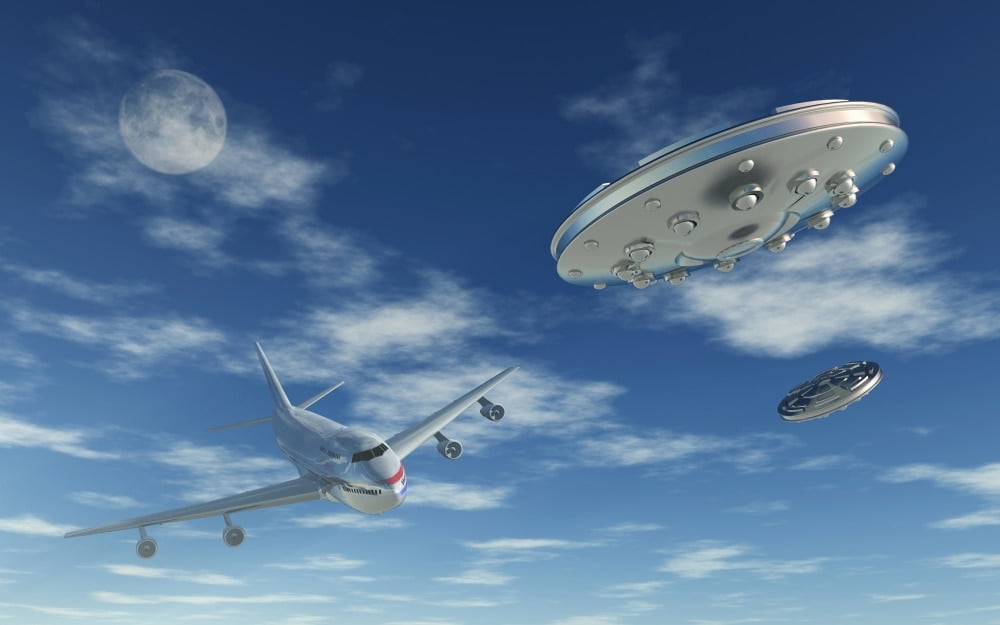 A pair of silver metallic disc shaped UFO's buzzing a Boeing 747 ...