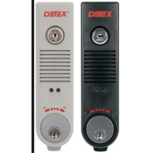 Detex EAX-500 Surface-Mounted Exit Alarm in gray, designed for narrow stile doors with a tapered cover. Features include a 100dB piezo horn for door use alerts, an intelligent circuit for automatic handing detection, and a patented cam assembly for cylinder size adjustments. The image displays two units, one gray and one black, with key slots, on/off indicators, and modern cover graphics.