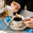 thumbnail image 4 of ANJORALA 14 Pcs Tea Cup Sets for Adult,Ceramic Coffee Cups with Metal Holder,Spoon,Saucer(Gold Leaf), 4 of 8