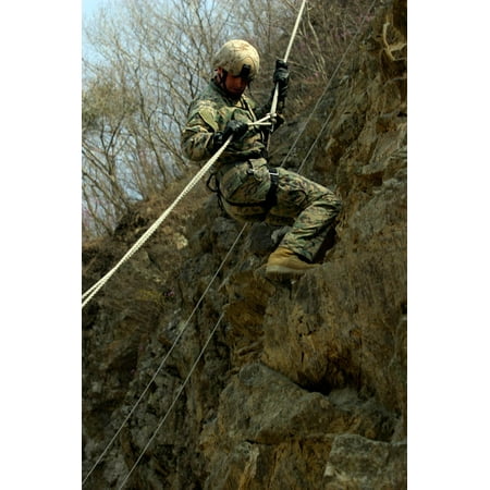 A Deep Reconnaissance Platoon team leader rappels down a cliff Poster Print by Stocktrek