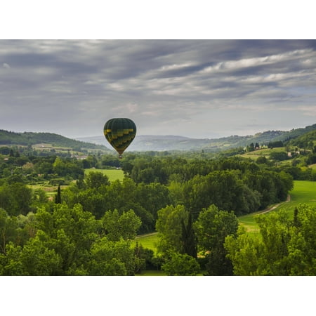 A hot air balloon flies low over a spring valley landscape Tuscany Italy Canvas Art - Brian Guzzetti  Design Pics (17 x