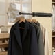 thumbnail image 1 of Organizador de armario de pared con diseño deslizante: barra para colgar ropa extensible y temporal para el almacenamiento en armarios domésticos., 1 of 6