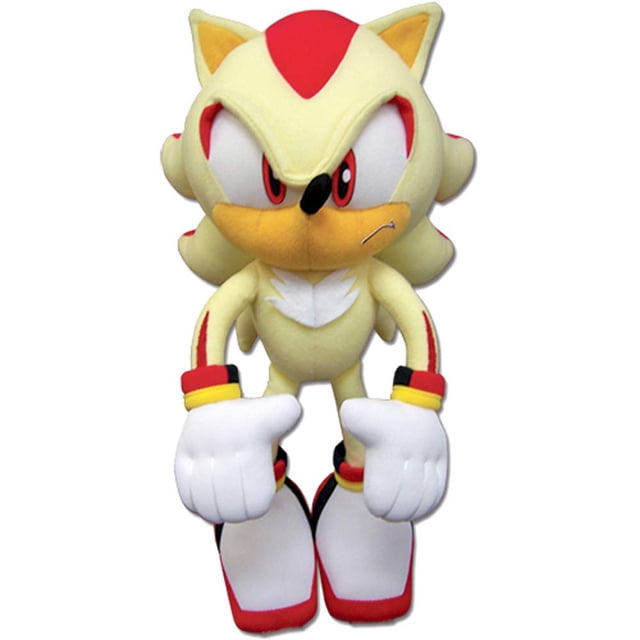 peluche sonic the hedgehog great eastern super shadow 12 cm multicolor, vista frontal centrada del peluche Super Shadow de pie, cabeza y orejas puntiagudas, ojos bordados rojos y blancos, hocico y pecho color crema, guantes blancos acolchados y botas blancas con suela roja; fondo blanco neutral. A menudo usado como pieza de colección o regalo.