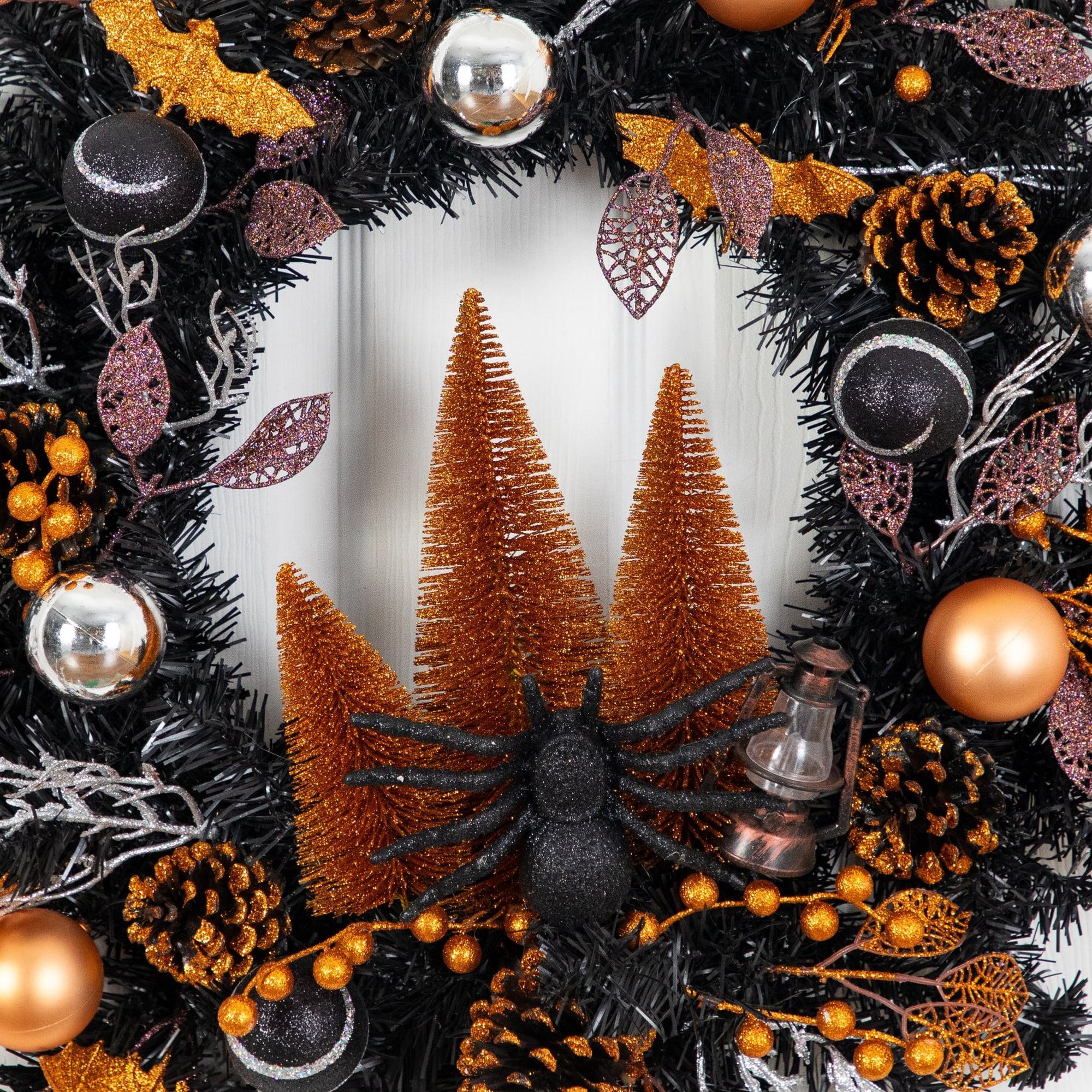 24in. Artificial Halloween Black Mixed Foliage Wreath with Bats, Pinecones and Trees