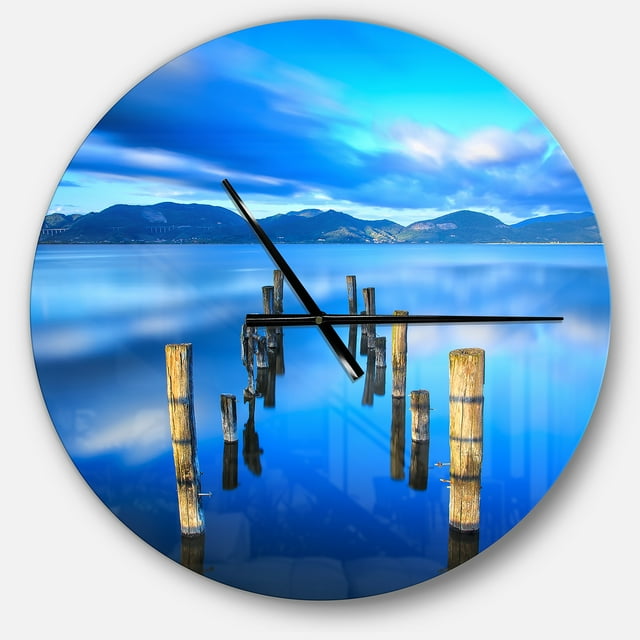 DesignArt Wooden Pier Remains in Blue Sea Large Wall Clock
