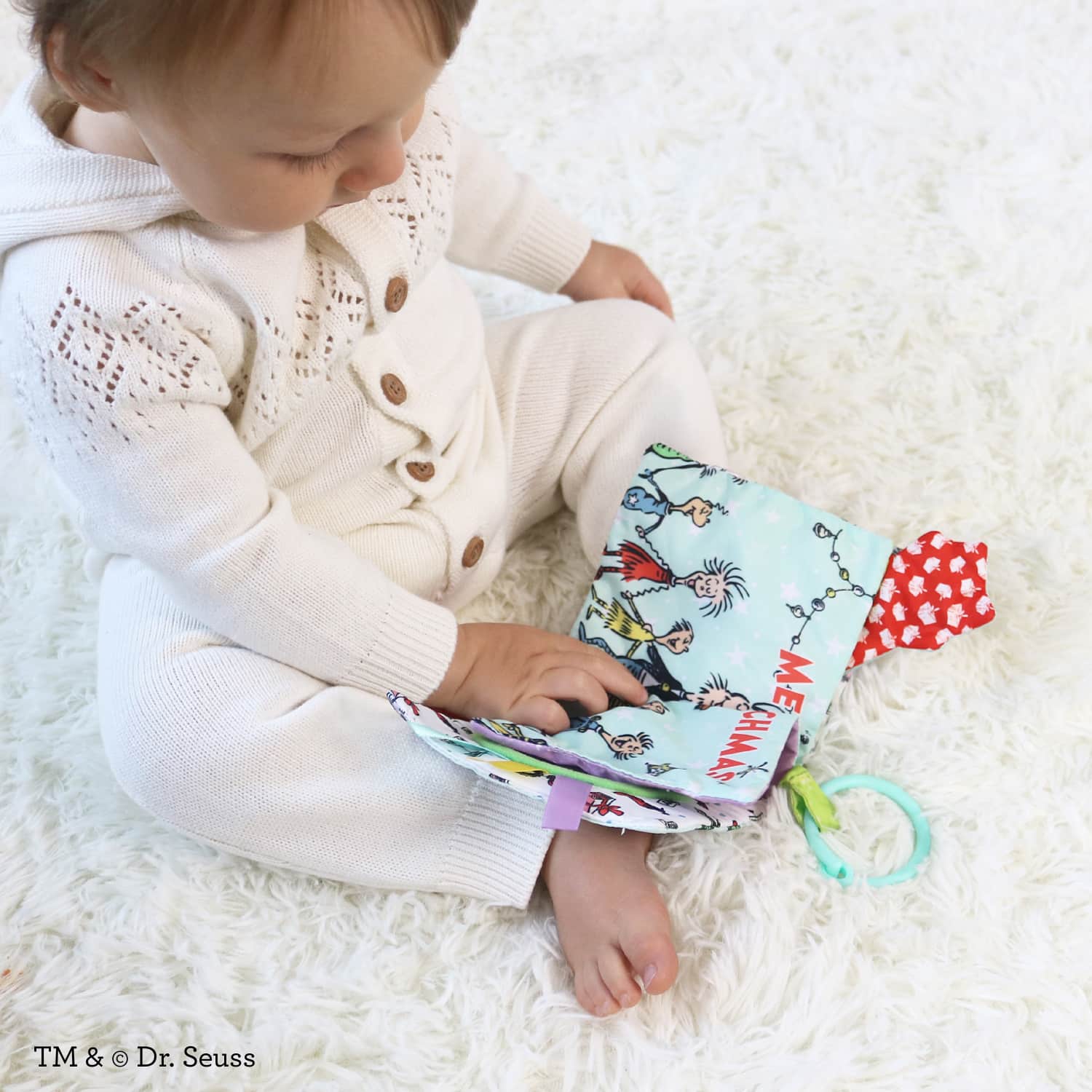 Infantino Lil’ Explorer Soft Book, The Grinch Holiday Sensory Toy for Babies with Crinkle, Squeaker & Clacker Rings