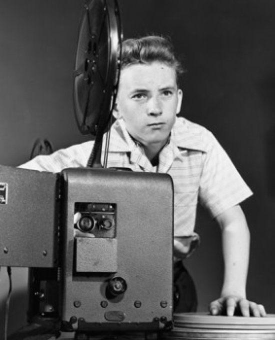 Boy adjusting a projector Poster Print Item VARSAL2557819A