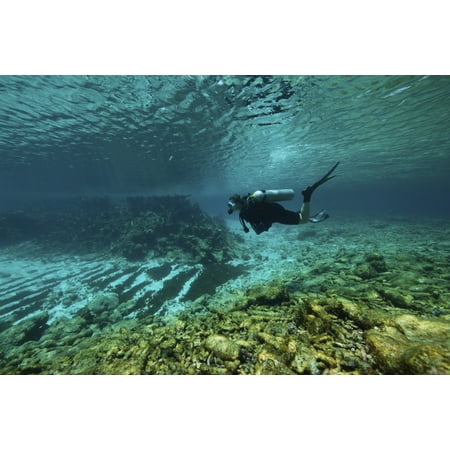 Diver swims through the shallow reef towards shore Bonaire Caribbean Netherlands Poster