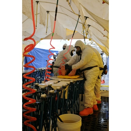Chemical Soldier LAMINATED POSTER Soldiers of the 436th Chemical Company wash and decontaminate a simulated casualty while wearing the Poster Print 24 x 36 ()