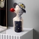 thumbnail image 3 of Figura de resina nórdica con burbujas de jabón, chica de pelo rizado con elegante sombrero de copa. gris, 3 of 8