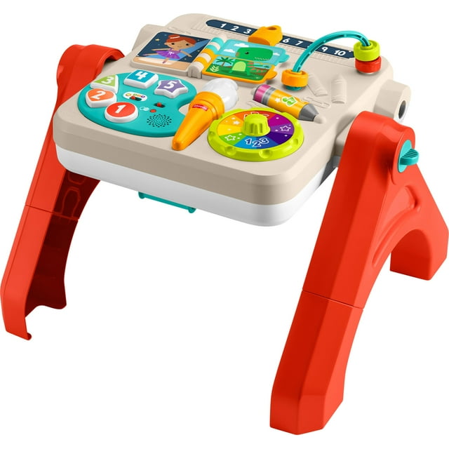 Fisher-Price 4-in-1 activity table for babies and toddlers featuring red foldable legs, colorful interactive buttons numbered 1 to 5, a toy microphone, spinning dial with numbers and stars, picture cards of characters and animals for electronic learning in multiple languages.