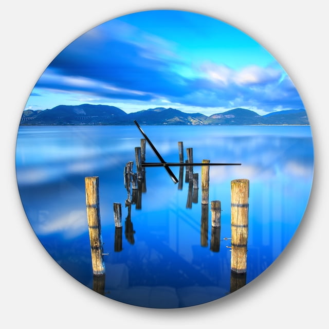 Designart 'Wooden Pier Remains in Blue Sea ' Modern wall clock