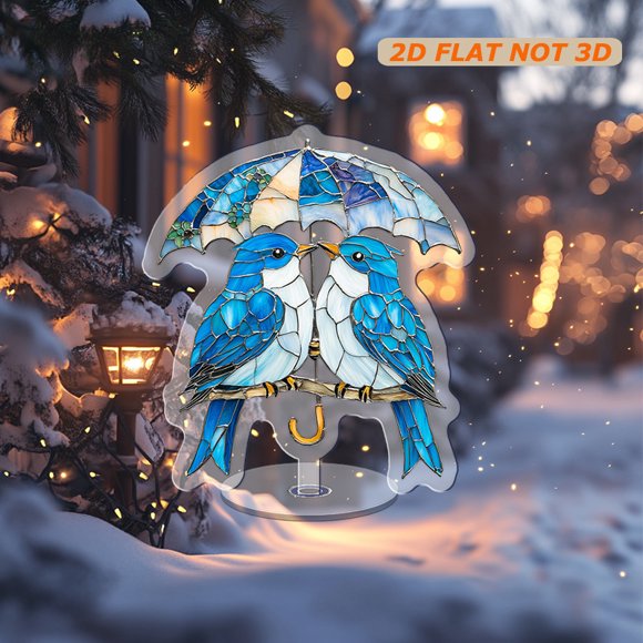 Rotating acrylic ornament featuring two light blue birds with white bellies under umbrellas in a vibrant stained glass mosaic style