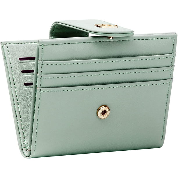 Credit card holder with coin outlet pocket