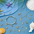 thumbnail image 2 of Juego de 100 colgantes de estilo tibetano con forma de concha, estrella de mar, delfín y peces marinos, surtidos en 20 estilos., 2 of 9
