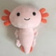 thumbnail image 2 of Bonita almohada de peluche con forma de ajolote, de dibujos animados (amarillo), 2 of 4