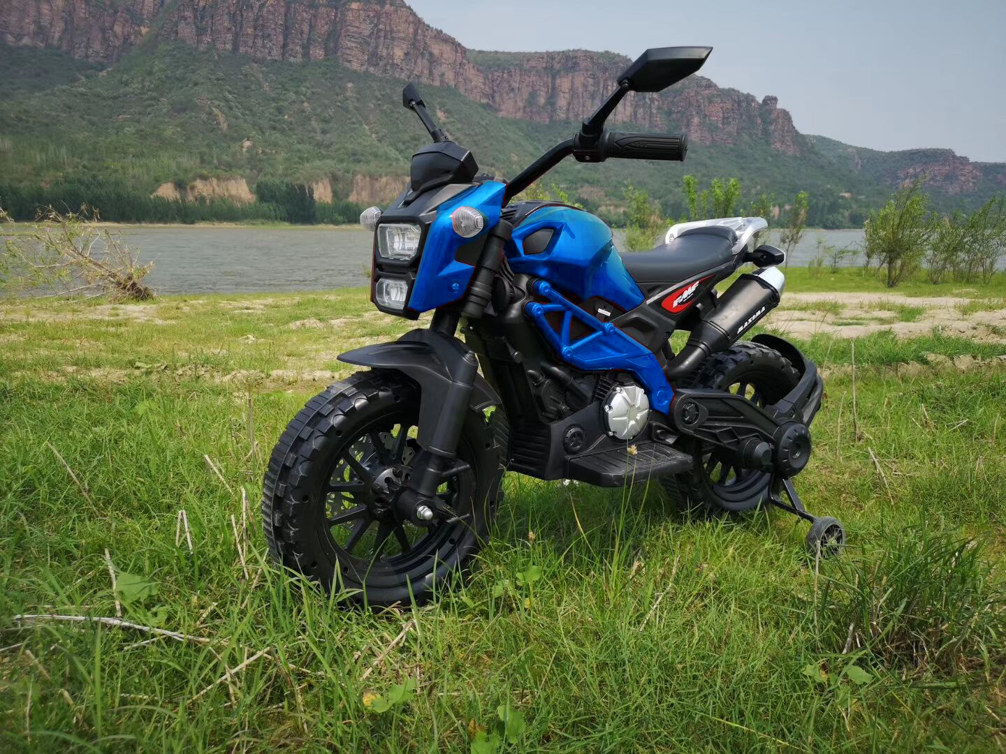 Electric MotorcycleFor Kids, Tamco 12V7AH Ride On Dirt Bike Toys, Gift For 3~6 Years Boys Girls With Training Wheels, Hand Racing/ Foot Brake/PU seat Goods Weight 40 LB