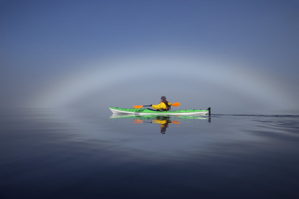 A Sea Kayaker Paddles Along The Edge Of A Thick Fog Bank In Southeast Alaskas Stephens Passage A Fog Bow Has Formed Where Water Particles Reflect The Light Of The Morning Sun Mr Ed Emswiler Id#1217201