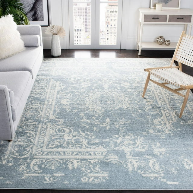 Safavieh Adirondack Zoey traditional faded area rug with intricate floral and scroll motifs in light blue and cream, styled in a bright living room.