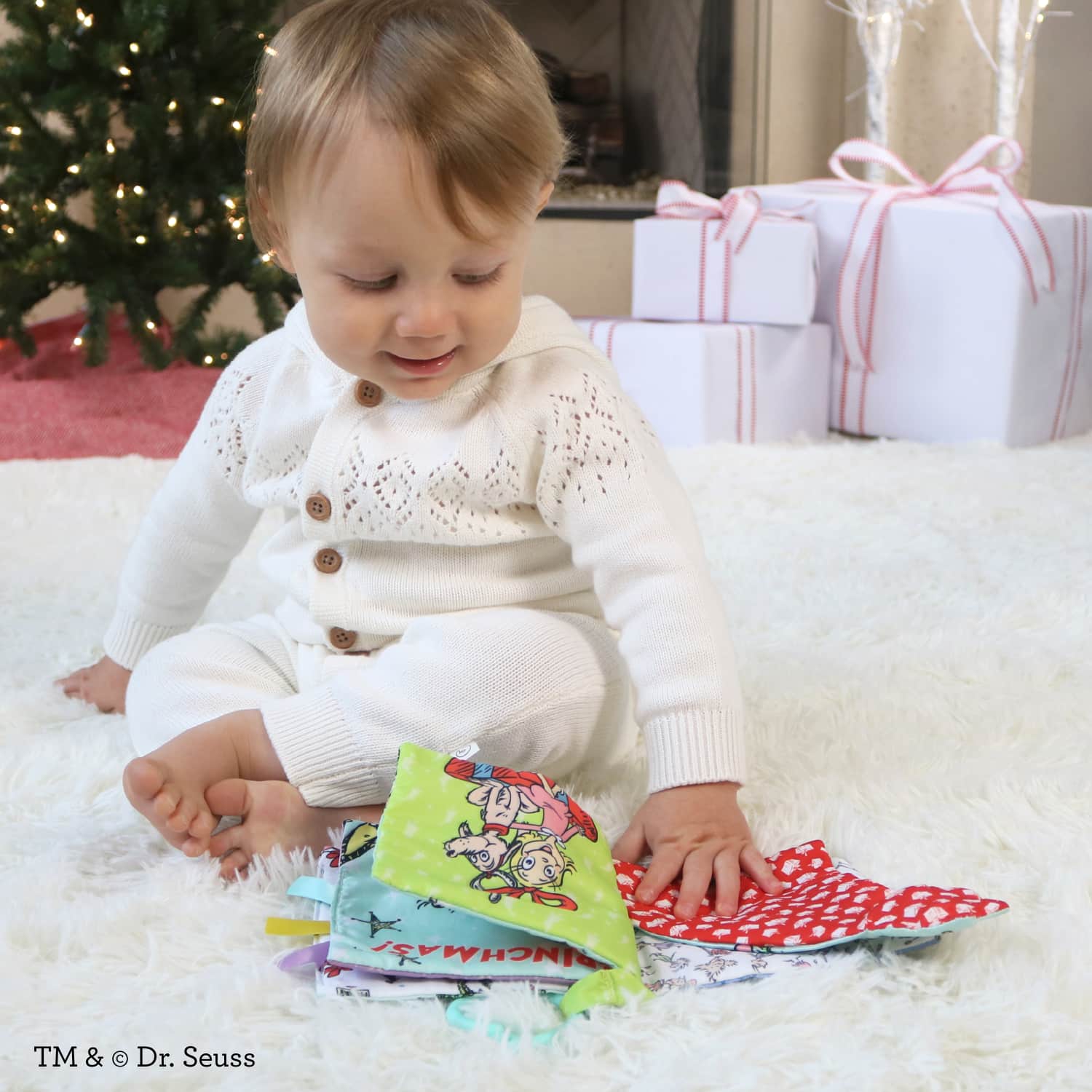 Infantino Lil’ Explorer Soft Book, The Grinch Holiday Sensory Toy for Babies with Crinkle, Squeaker & Clacker Rings