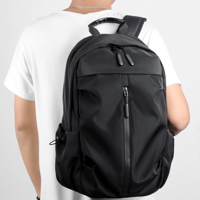 Kcavykas Clearance Sales Home Storage Organiser Laptop Backpack for Women & Men, crafted from durable black nylon with a sleek design. Features include a padded laptop compartment for 15.6-inch laptops, spacious storage, and multiple organizational pockets. The backpack is worn by a person in a casual setting, showcasing adjustable mesh shoulder straps and sturdy construction. Ideal for travel, business, college, or casual hiking.