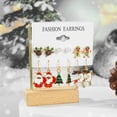 thumbnail image 4 of Juego de pendientes de botón navideños para mujer 2025, pendientes de aro con decoración de alce, árbol de Navidad, muñeco de nieve y luna, joyería para oreja perforada, regalo, 4 of 5