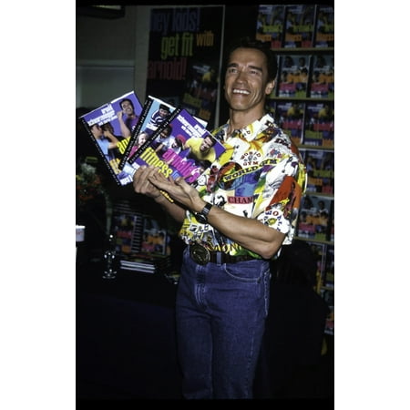 Arnold Schwarzenegger with his books Arnolds Fitness for Kids Photo