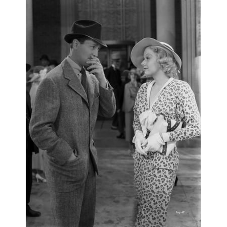 Jean Harlow Scene from a Film standing in White Collar V-Neck Long Sleeve Dress and Straw Hat while Talking to a Man in Tweed Sport Coat Photo