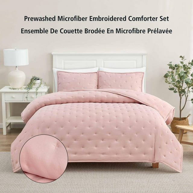 Double queen pink blush microfiber comforter set with embroidered tufted pattern displayed on a white bed frame in a modern bedroom.