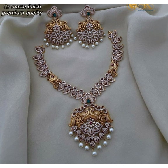 Haya Jewel South Indian Bollywood Gold Plated Peacock & Mango Design Necklace Set with Ruby, Green & White Stones, Pearls, Matte Finish Pendant, and Drop Earrings – AD CZ Bridal Jewelry Set