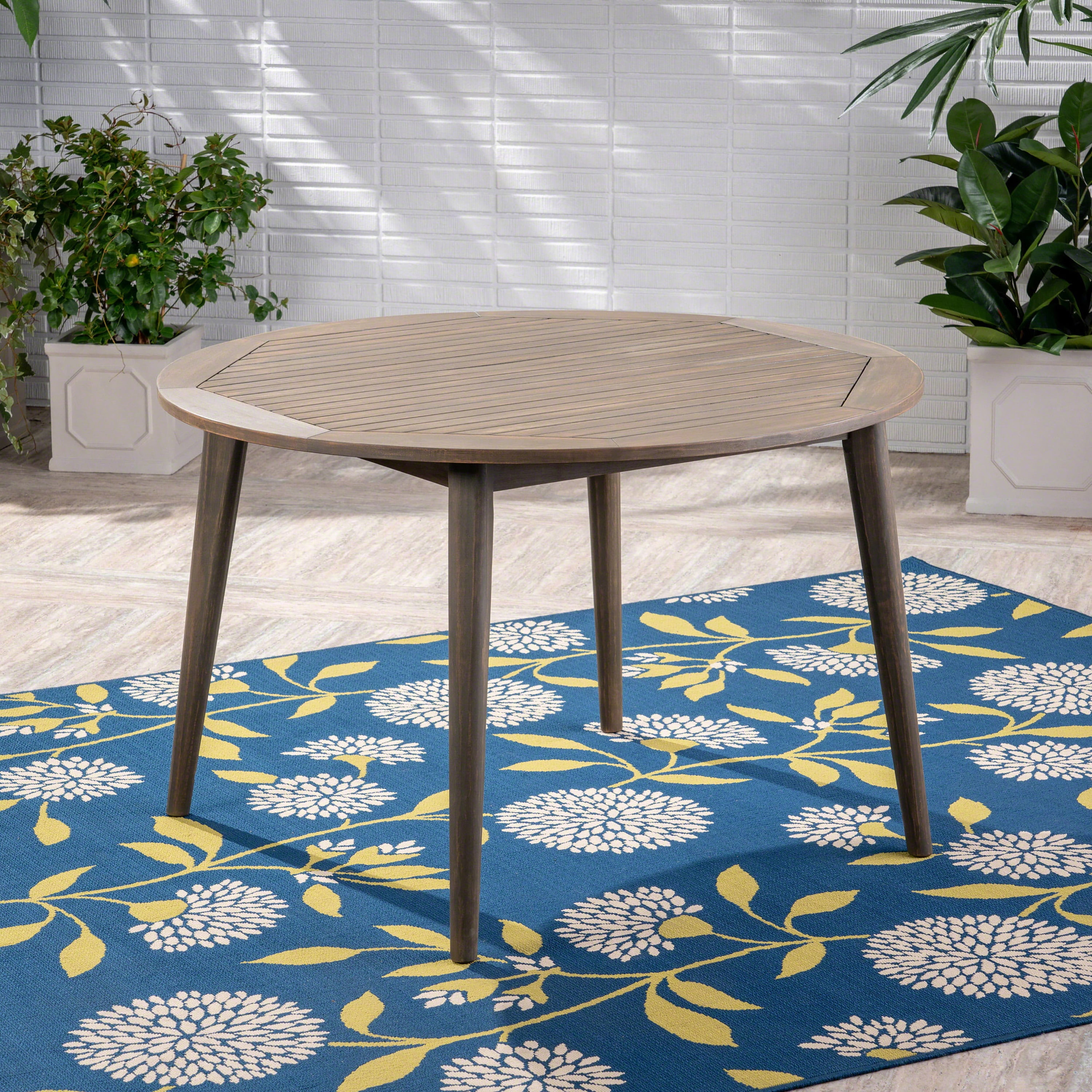 Euroco simple and sleek acacia wood dining table is the perfect addition to any backyard space