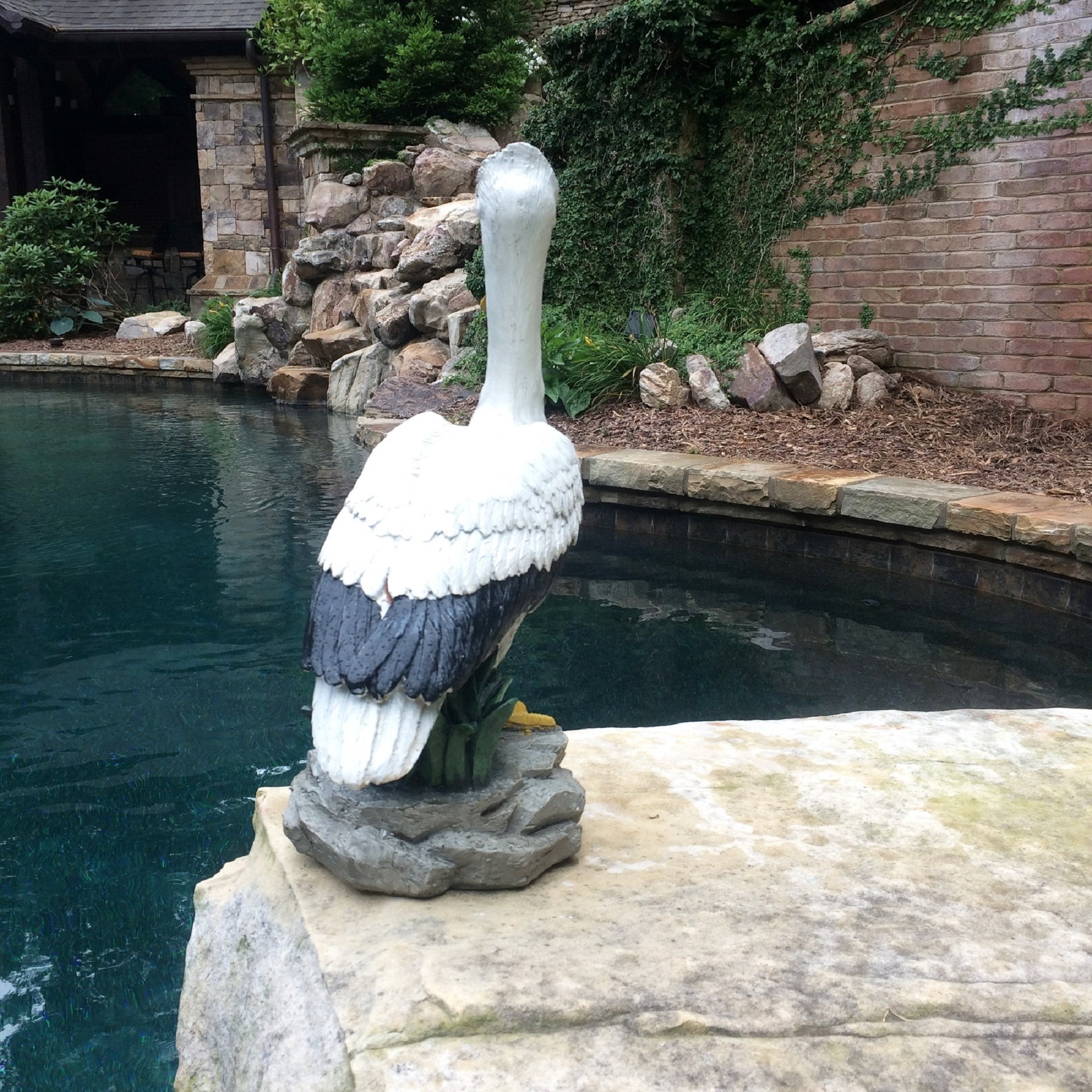 Homestyles 20 in. Pelican on Coastal Rock with Natural Finish Nautical Beach Statue Garden Statue