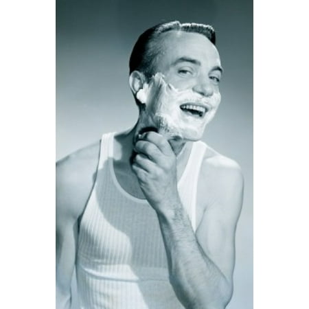 Studio portrait of man applying shaving cream Canvas Art - (24 x 36)