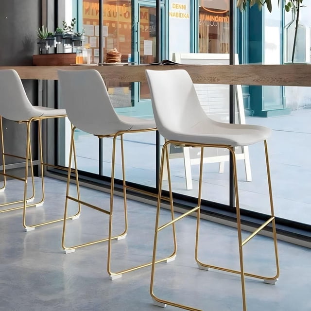 Heavenly Collection set of six white PU counter stools with sleek gold legs shown in modern kitchen setting.