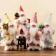 thumbnail image 1 of Adorno de Papá Noel de pie con sombrero cascabel • Figurita tradicional de Papá Noel con traje rojo de 11" • Colgante de árbol de Navidad y decoración para fiestas • Tela ligera no tejida, 1 of 4