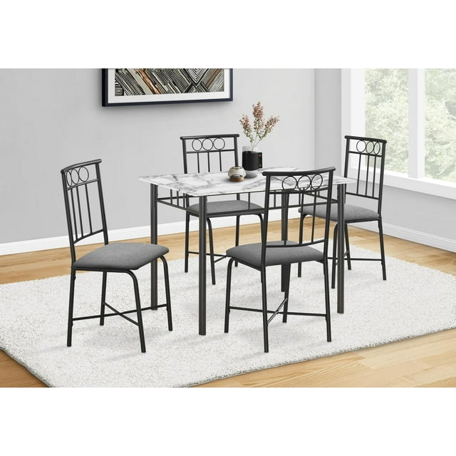 Monarch Specialties 5-piece dining set featuring a small 40-inch rectangular white marble look laminate table and four black metal chairs with gray cushioned seats in a modern kitchen setting.