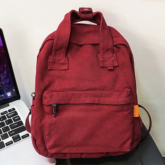 Mochila unisex de lona de color sólido con bolsillos laterales para estudiantes escolares (rojo vino)