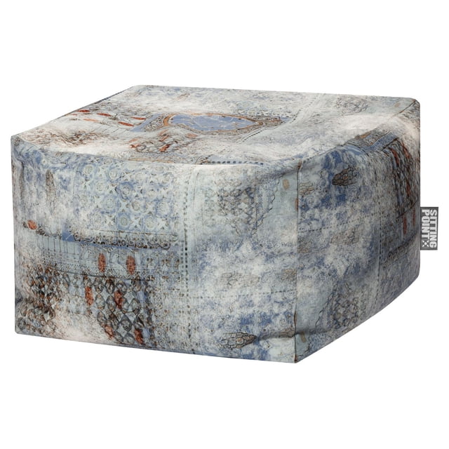 Sitting Point cube-shaped ottoman with a soft fabric cover featuring a distressed vintage pattern in muted blue, grey, and rust tones, suitable as kids bean bag chair or casual seating, shown in a close-up front and side view with a visible brand tag on the right side.