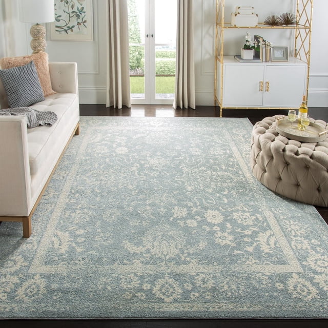 SAFAVIEH Adirondack Wyatt traditional area rug featuring a light blue and cream floral design in an elegant living room.