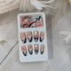 thumbnail image 3 of Uñas postizas medianas almendradas con puntas francesas azules y diseño floral blanco, juego de 24 piezas., 3 of 4