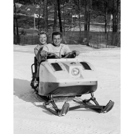 Mid adult couple snowmobiling Canvas Art - (18 x 24)