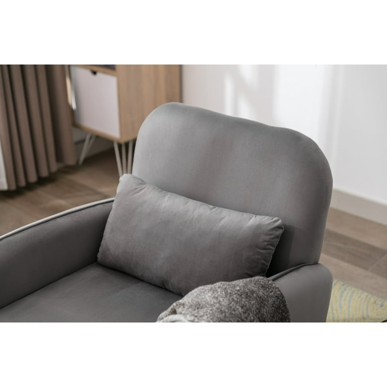 A charcoal gray striped lumbar pillow sits atop a wood and wicker accent  chair positioned at the corner of a white and gray…