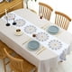 thumbnail image 3 of Se producen flores de colores vivos bordadas con un mantel ovalado de color blanco cremoso., 3 of 5
