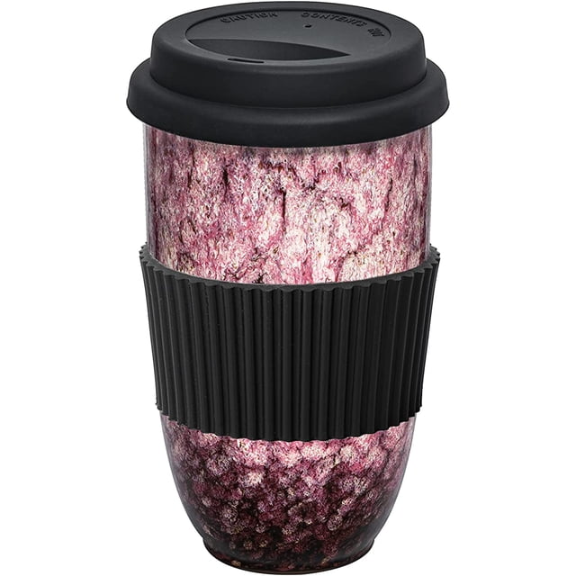 Travel Ceramic Reusable Coffee Travel Mug with Lid and Sleeve - 16oz. Large, showcasing a pink reactive glaze ceramic finish with artisan aesthetic. Features a black silicone lid and ribbed sleeve for heat resistance and grip. Portable tumbler, microwave and dishwasher safe, eco-friendly, BPA-free, suitable for hot or cold beverages.