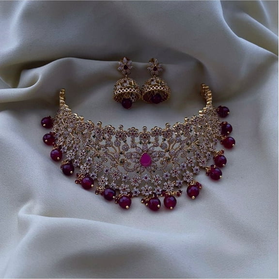 Haya Jewel South Indian Bollywood Gold-Plated Royal Leaf & Flower Nakshi Choker Necklace Set with Ruby, Green & White Kemp Stones, Maroon Pearl Guttapusalu, Jhumki Earrings & Maangtikka