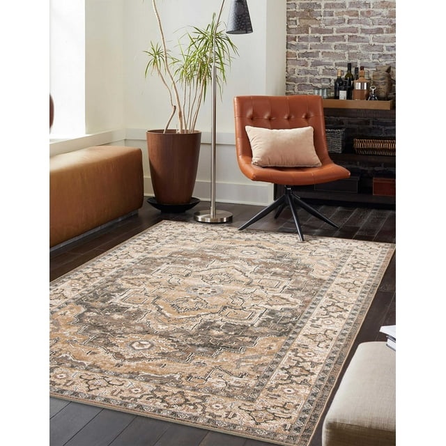 ECARPET Ashby traditional area rug featuring beige, brown, and gray geometric patterns on dark hardwood flooring in a contemporary living room with leather chair and potted plant.