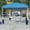 Blue, variant on Tent Set-10'x10' Wheeled Blue Canopy Tent, 6-Foot Table, 4 White Folding Chairs