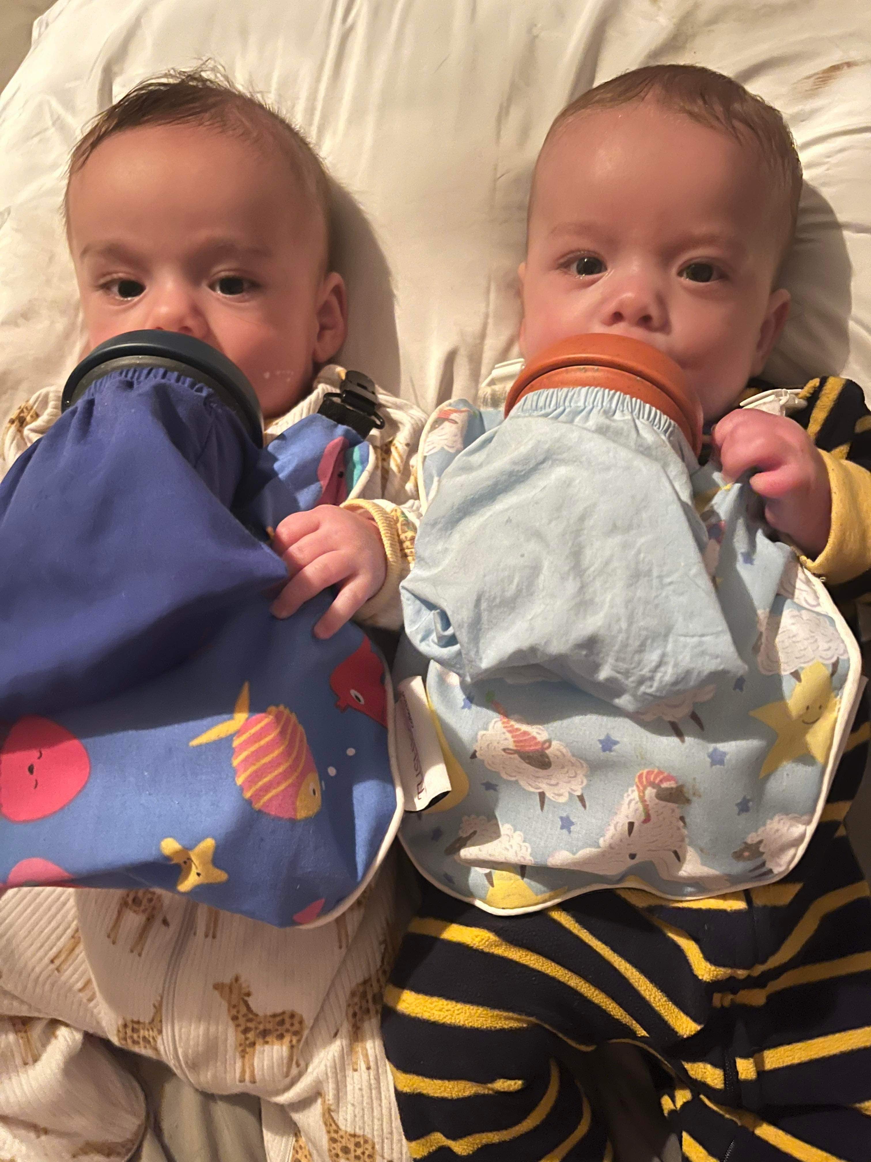 The Bottle Bib-Lullaby Collection Pink Keeps baby bottles, food pouches and training cups, from falling onto dirty surfaces!  Hands free Feeding! Check it out!
