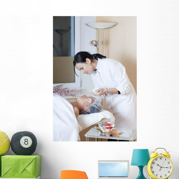 Beautician Applying Facial Mask Wall Mural by Wallmonkeys Peel and Stick Graphic (48 in H x 32 in W) WM166900